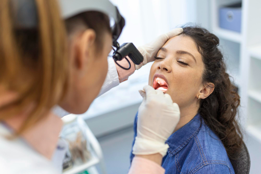 dentist doing mouth cancer screening for patient