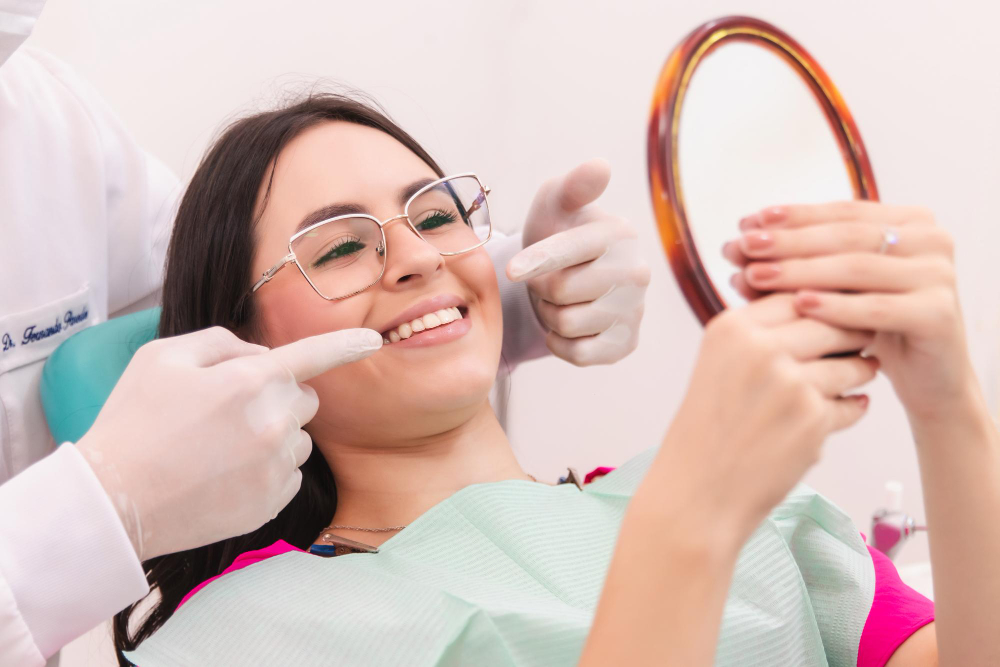 woman looking in the mirror after composite bonding treatment